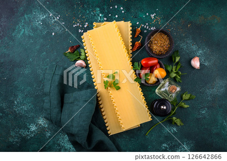 Uncooked lasagna pasta with cooking ingredient Uncooked lasagna pasta with cooking ingredient 126642866