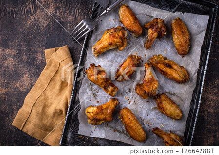 Baked spicy chicken wings with sauce 126642881