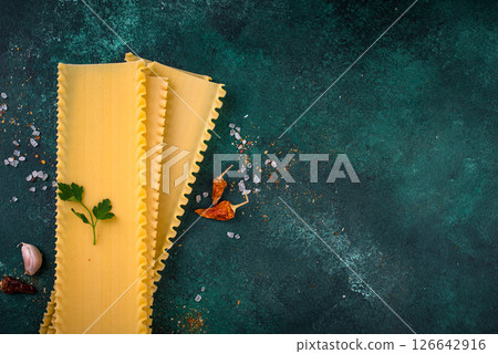 Uncooked lasagna pasta with cooking ingredient Uncooked lasagna pasta with cooking ingredient 126642916