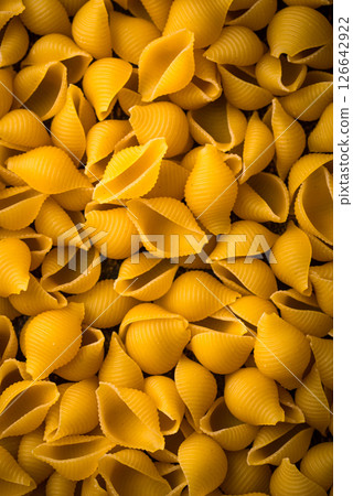 Raw pasta in shape of shells Raw pasta in shape of shells 126642922