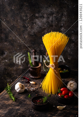 Italian food background with spaghetti, tomato and spices 126643021