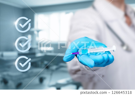 Medical professional preparing syringe for vaccination 126645318