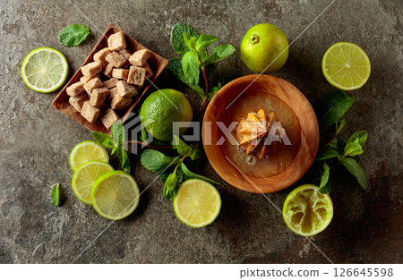 Wooden citrus squeezer and ingredients for making summer refreshing drinks. 126645598