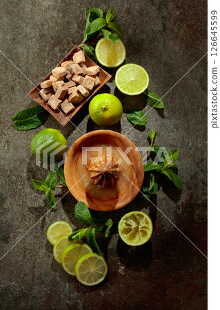 Wooden citrus squeezer and ingredients for making summer refreshing drinks. Wooden citrus squeezer and ingredients for making summer refreshing drinks. 126645599