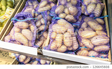 Fresh potatoes packed in bags selling at the grocery store 126645608