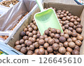 Unpeeled macadamia nuts are sold in a grocery store 126645610