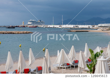 Beach with white sand and beach chairs and red towels 126645613