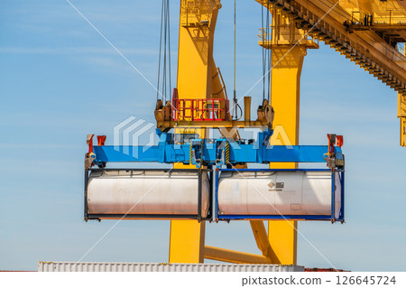 Container Crane Lifting Tank Container at Port Terminal 126645724