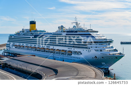 Large Cruise Ship Docked at Port Terminal on a Sunny Day 126645733