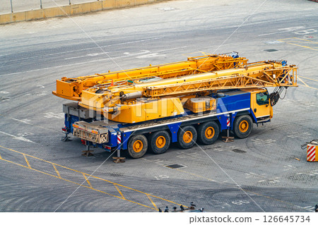 Mobile Crane Truck in Industrial Yard. Heavy Equipment for Construction and Lifting Mobile Crane Truck in Industrial Yard. Heavy Equipment for Construction and Lifting 126645734