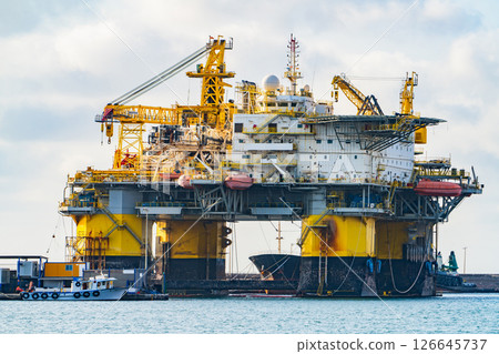 Offshore Oil Platform Docked in Port. Industrial Maritime Infrastructure 126645737