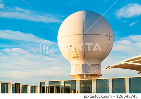 Spherical Radar Dome on Rooftop Against Blue Sky. Modern Technology Structure 126645743