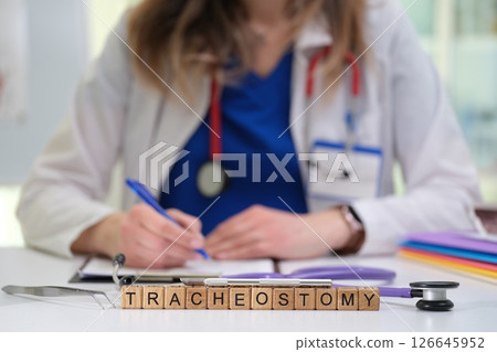 A skilled medical professional is expertly performing a tracheostomy in a clinical setting 126645952