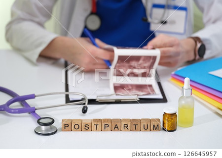 Postpartum Care A Doctor with Health Tools and Ultrasound Images offering support 126645957