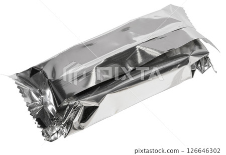 Close up of empty silver foil packaging for candy bar or snack, crumpled and sealed, isolated background. Close up of empty silver foil packaging for candy bar or snack, crumpled and sealed, isolated background. 126646302