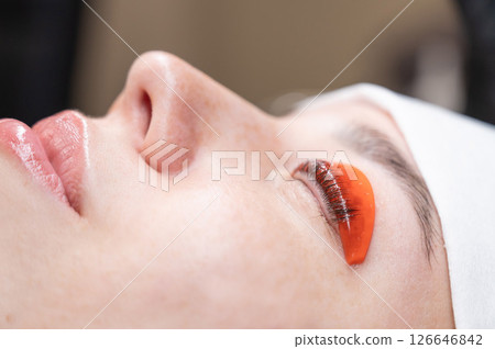 Caucasian woman undergoing eyelash lamination procedure.  126646842
