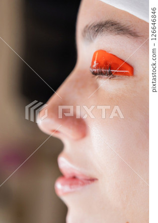 Caucasian woman undergoing eyelash lamination procedure.  126646846