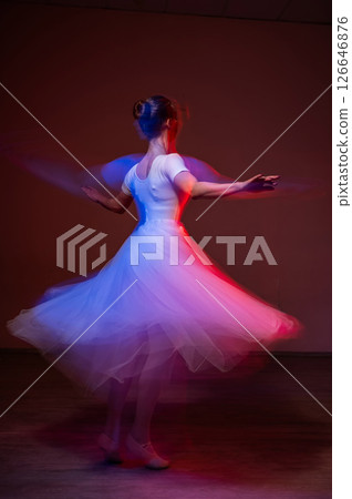 Caucasian woman dancing classical dance in tutu . Long exposure photo.  126646876