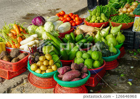 Colorful baskets of fresh vegetables at a vibrant outdoor market on a sunny day in Southeast Asia 126646968