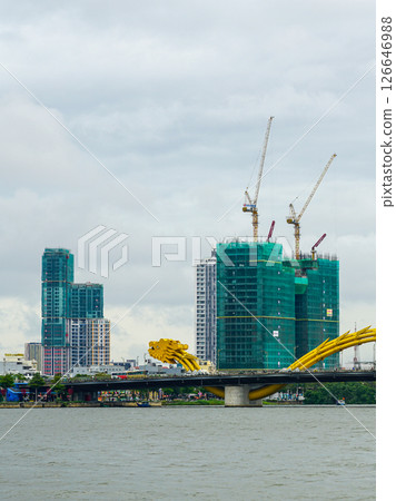 View of the iconic Dragon Bridge in Da Nang, Vietnam with skyscrapers and cranes in the background View of the iconic Dragon Bridge in Da Nang, Vietnam with skyscrapers and cranes in the background 126646988