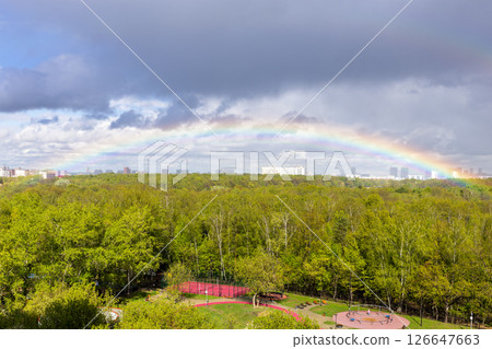 rainbow over green park and playground after rain rainbow over green park and playground after rain 126647663