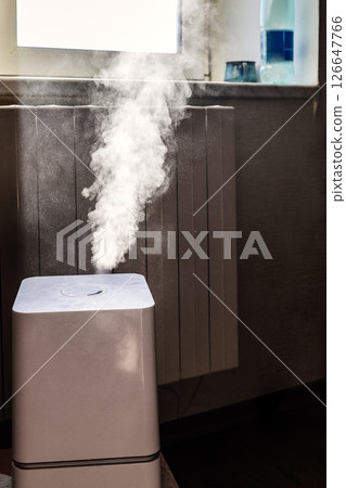 household humidifier emitting water in living room household humidifier emitting water in living room 126647766