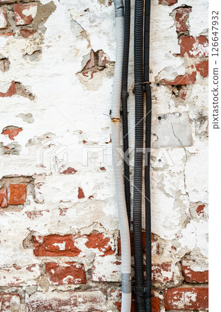 wires and cables on old brick wall in monastery wires and cables on old brick wall in monastery 126647932