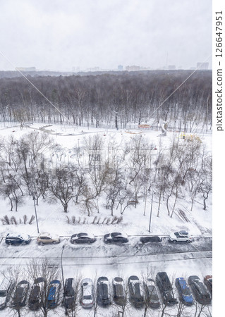 car park near city park covered with spring snow car park near city park covered with spring snow 126647951
