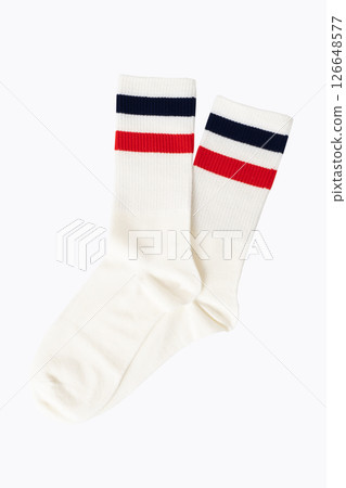 White athletic socks with red and navy stripes on plain background 126648577