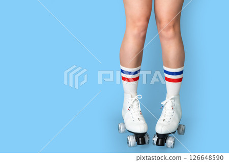 Retro roller skates on caucasian female legs with colorful socks 126648590