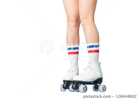 Vintage roller skating with white boots and striped socks on female legs Vintage roller skating with white boots and striped socks on female legs 126648602