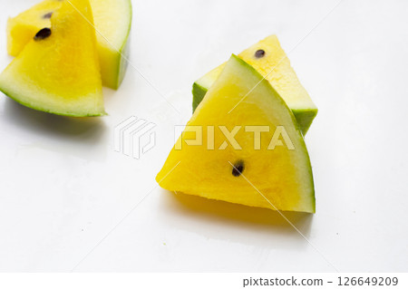 Yellow watermelon slices on white background. Yellow watermelon slices on white background. 126649209