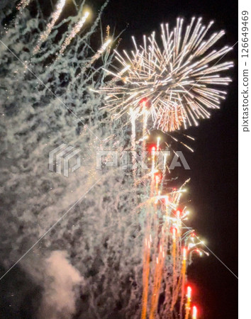 The night sky and the water surface create a fantastical glow. The beauty of the fireworks will make you forget time and it will captivate your heart. 126649469