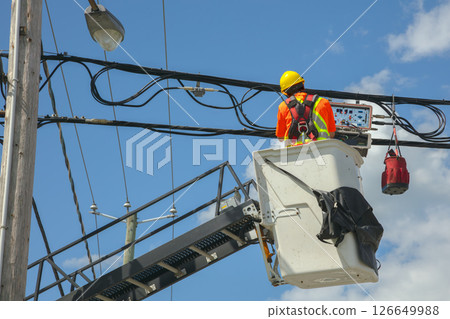 Utility Worker on Lift Repairing Power Lines 126649988