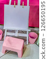 Mockup of Childrens Art Easel with Blank Paper, Pink Stool and Buckets in Playroom Setup Mockup of Childrens Art Easel with Blank Paper, Pink Stool and Buckets in Playroom Setup 126650195