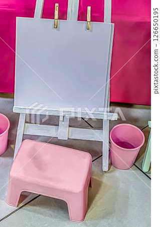 Mockup of Childrens Art Easel with Blank Paper, Pink Stool and Buckets in Playroom Setup Mockup of Childrens Art Easel with Blank Paper, Pink Stool and Buckets in Playroom Setup 126650195