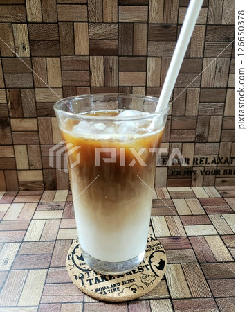 Iced cafe au lait with a straw Iced cafe au lait with a straw 126650378