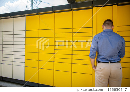 A person engages with a contemporary modern art installation in an urban outdoor setting A person engages with a contemporary modern art installation in an urban outdoor setting 126650547