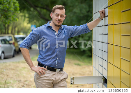 A Confident Young Man Posing Outdoors Against a Backdrop of Modern Urban Architecture A Confident Young Man Posing Outdoors Against a Backdrop of Modern Urban Architecture 126650565