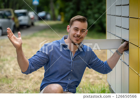 A Charming Young Man Joyfully Posing Outdoors in a Fun and Vibrant Natural Setting 126650566