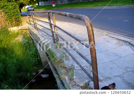 rusty old railing and footbridge on the street car in the background rusty old railing and footbridge on the street car in the background 126650652