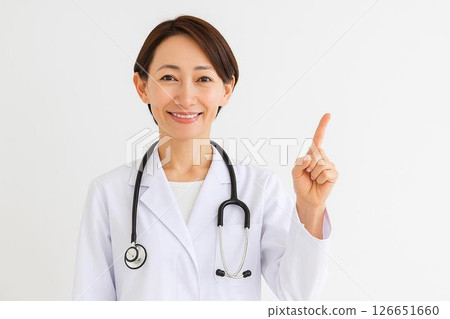 Smiling female doctor pointing and guiding | Perfect for explaining medical services 126651660