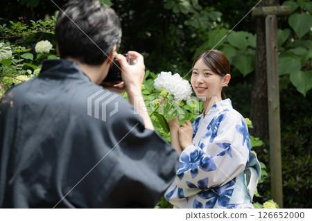 A couple enjoying sightseeing: Boyfriend taking a photo of his girlfriend A couple enjoying sightseeing: Boyfriend taking a photo of his girlfriend 126652000