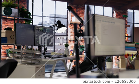 PC in empty IT startup office displaying programming languages used for building applications. Computer screen in software development agency showing code, trucking right shot PC in empty IT startup office displaying programming languages used for building applications. Computer screen in software development agency showing code, trucking right shot 126653306