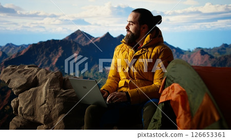 Young entrepreneur always connected to internet to do some tasks, workaholic person enjoying high speed strong signal and technology dependency. Hiker with an addiction. Camera A. 126653361