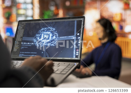 Call center worker uses AI technology on laptop to provide quick replies to common customer queries, close up. Customer service agent generates automated responses to clients using AI tech on notebook 126653399