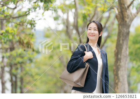 Business woman walking outdoors Business woman walking outdoors 126653821