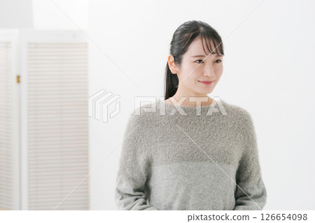 Portrait of a young woman wearing knitwear 126654098