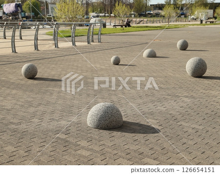 The installation features stunning spherical stone sculptures beautifully placed in an urban park The installation features stunning spherical stone sculptures beautifully placed in an urban park 126654151