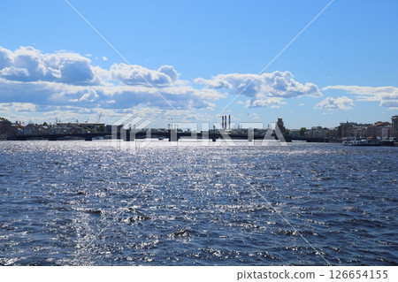 A Serene River Scene featuring a Scenic Bridge complemented by fluffy Clouds in the sky A Serene River Scene featuring a Scenic Bridge complemented by fluffy Clouds in the sky 126654155